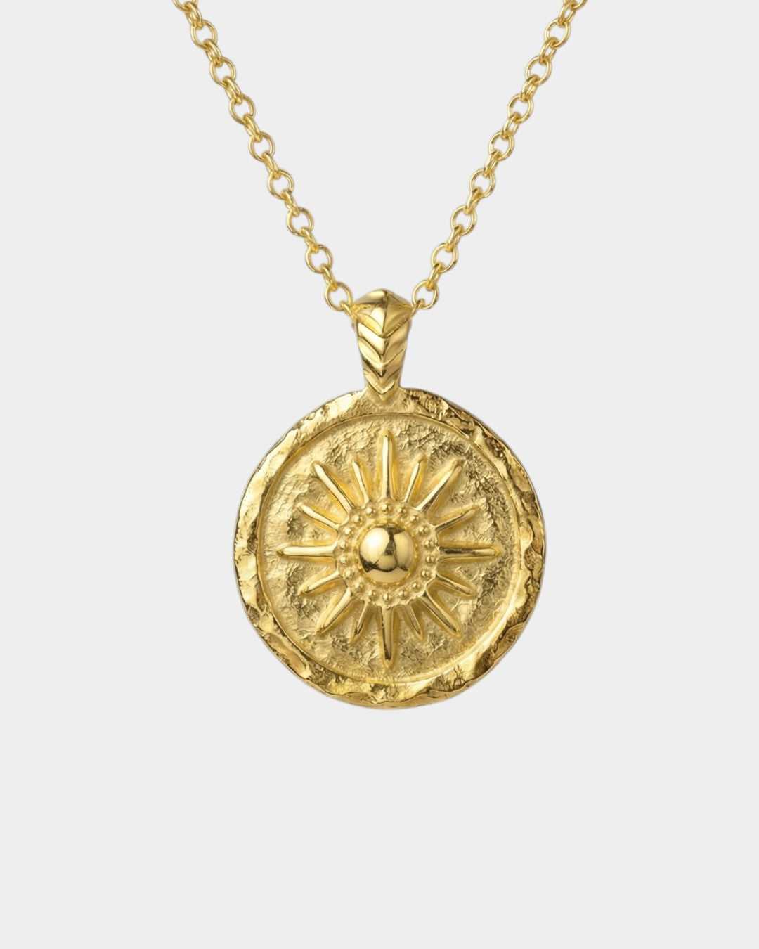 Gold necklace with a sun-shaped pendant on a white background