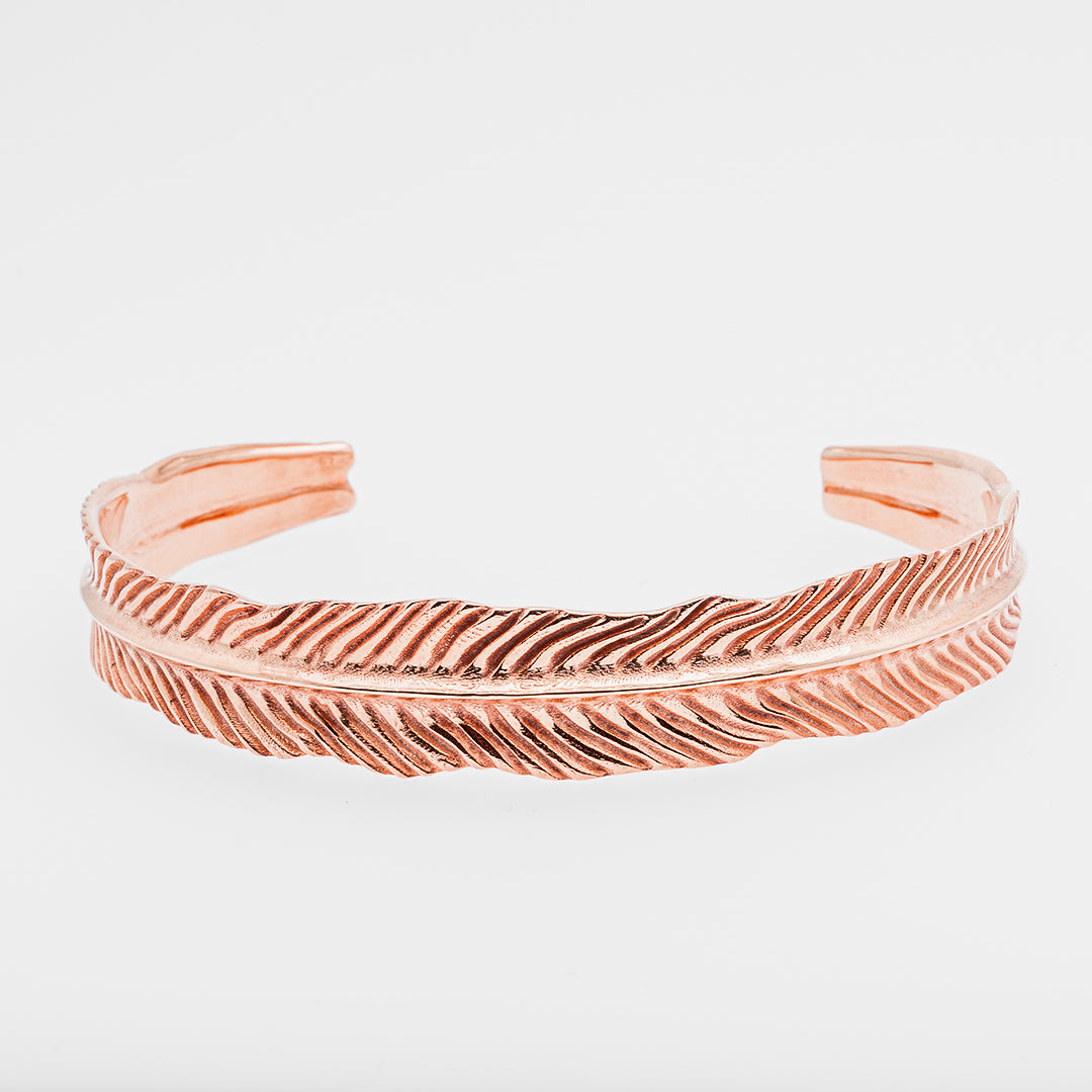Rose gold dragon's eye bracelet on a light gray background