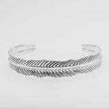 Silver dragon's eye bracelet on a light gray background