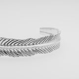 Silver dragon's eye bracelet on a light gray background
