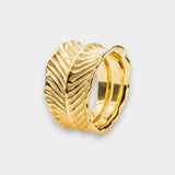 Gold ring with dragon's eye design on a light gray background