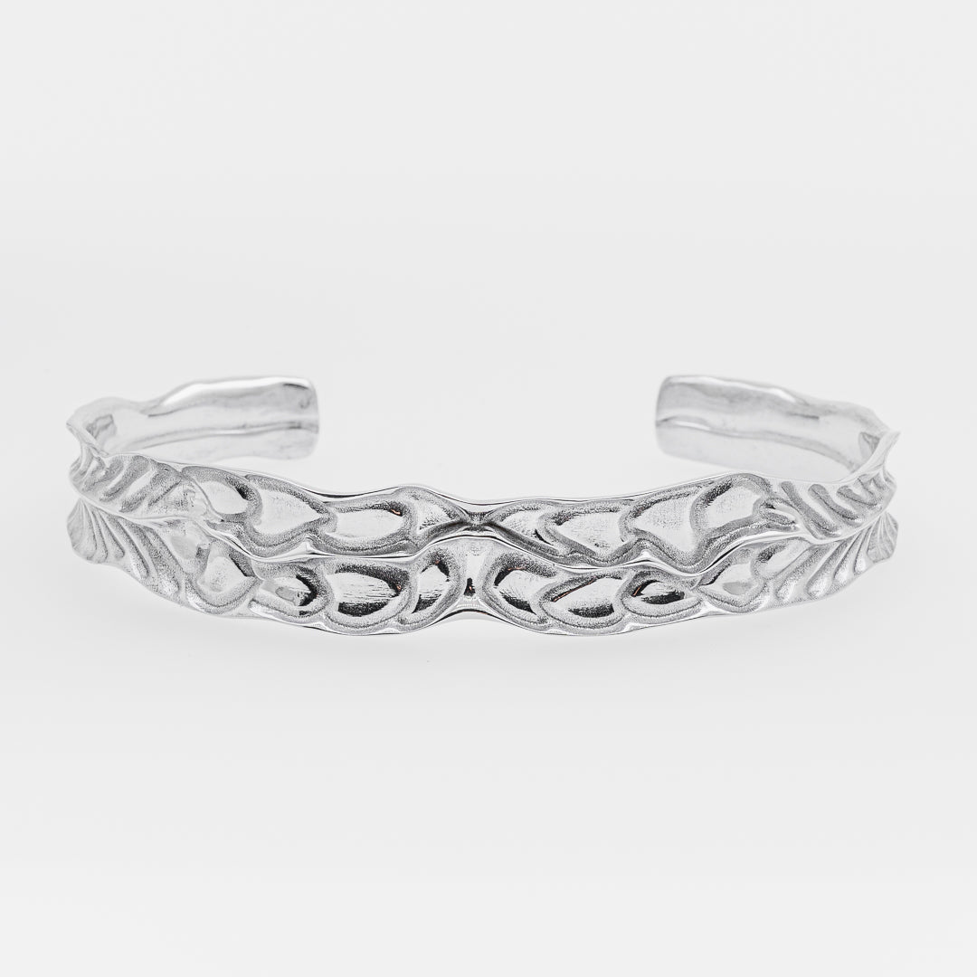 White gold bracelet on a light gray background