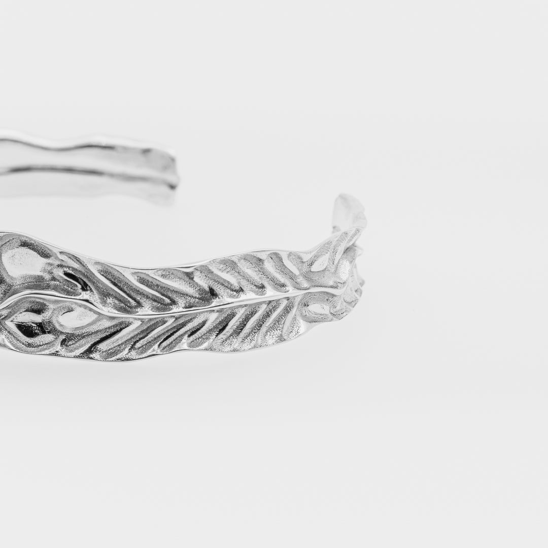 Silver dragon's eye-shaped ring on a light gray background