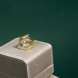 Gold ring on a silver jewelry box with a green background