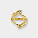 Gold leaf-shaped ring on a light gray background