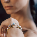 Close-up of a person's arm with elephant bracelets