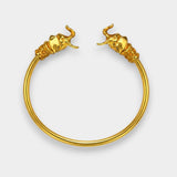 Gold elephant head hoop earrings on a white background