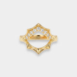 Gold ring with diamond accents on a light gray background