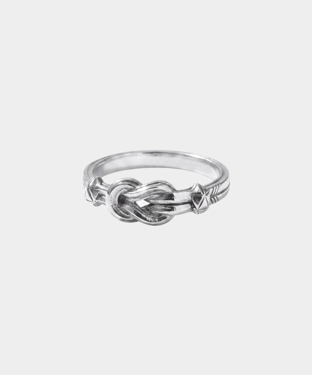 Silver knot ring on a light gray background