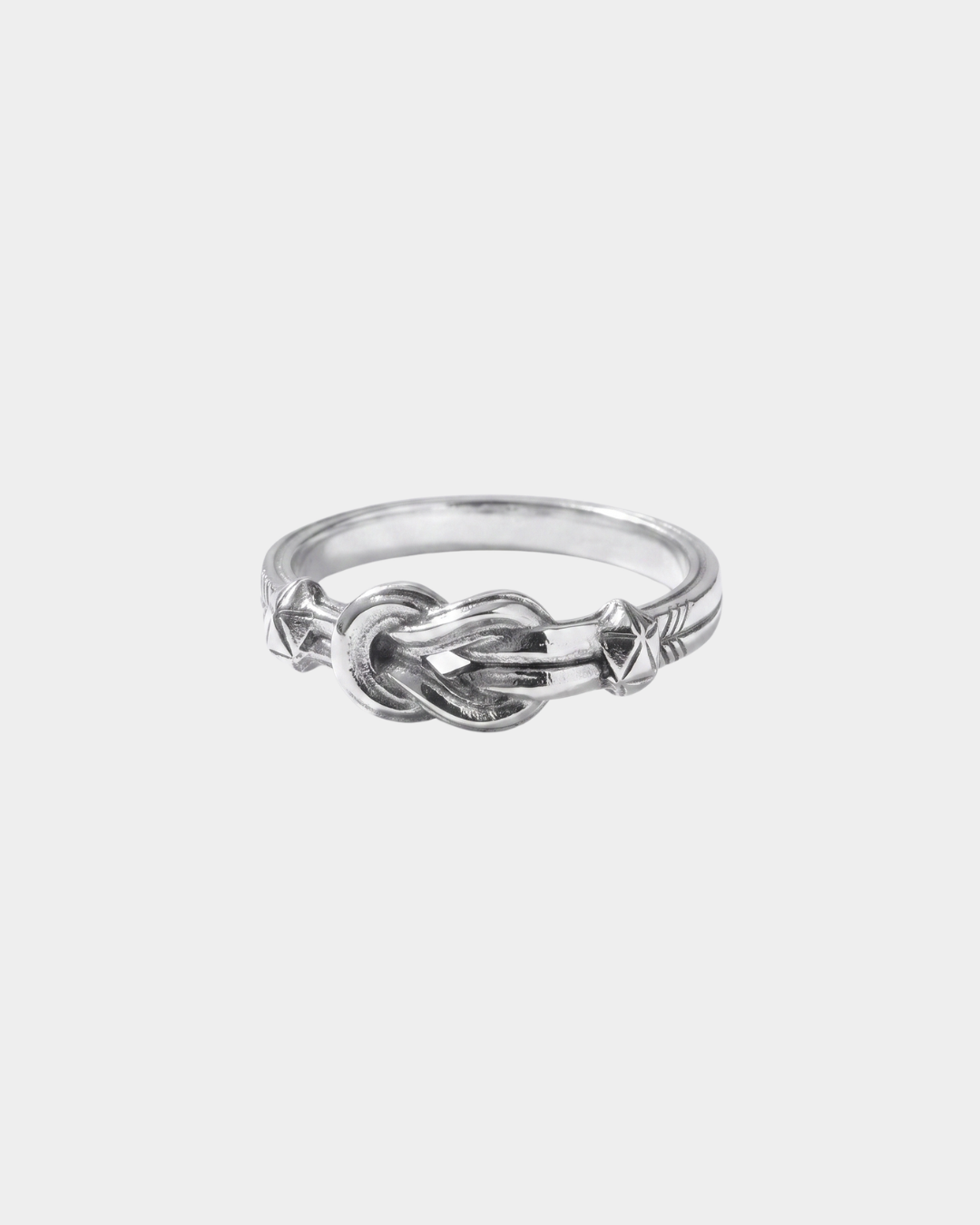 Silver knot ring on a light gray background