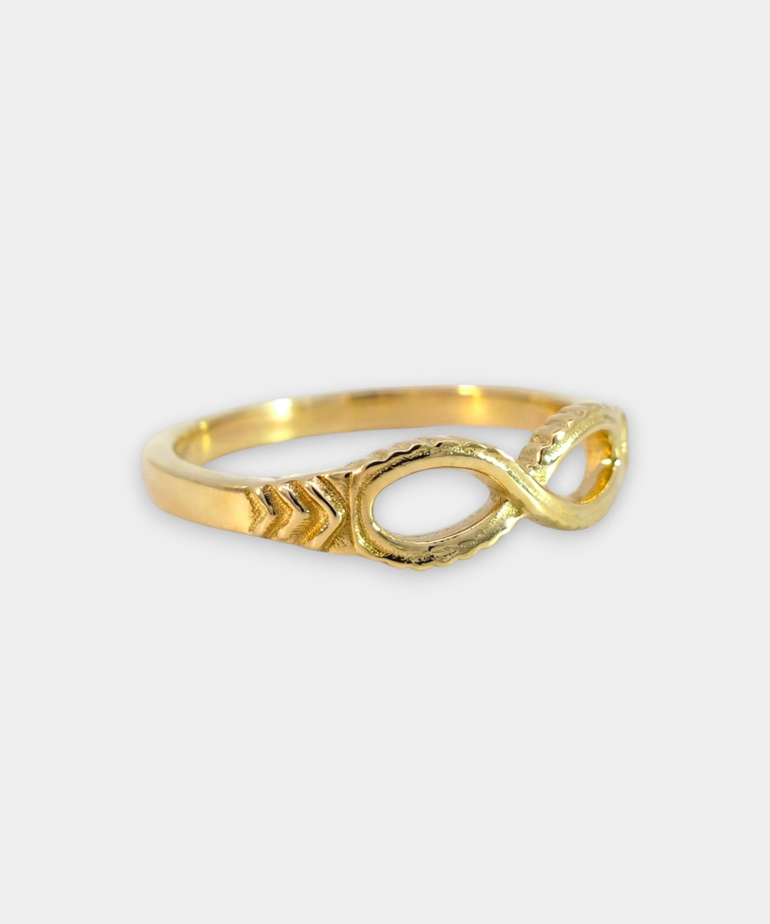 Gold infinity ring on a white background
