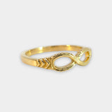 Gold infinity ring on a white background