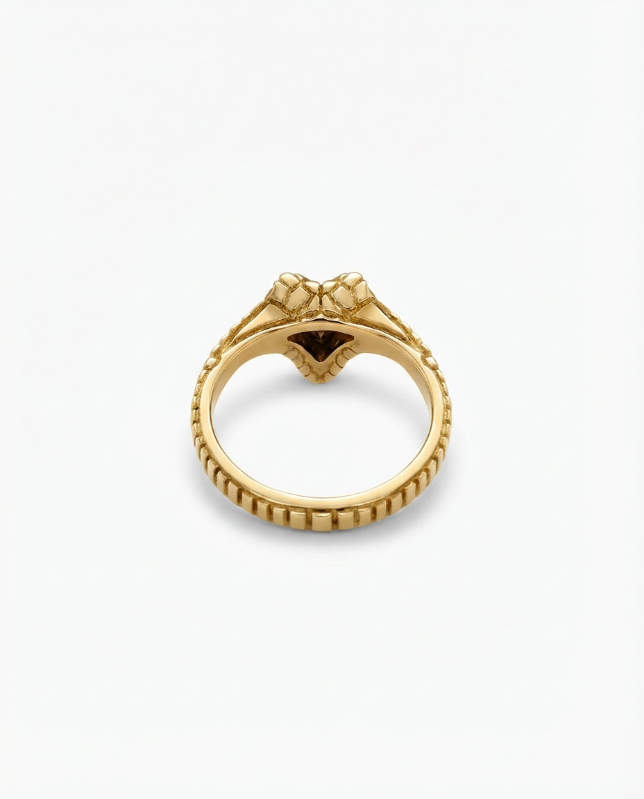 Gold ring with a snake head on a white background