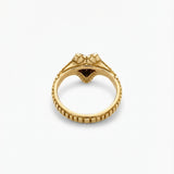 Gold ring with a snake head on a white background
