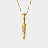 Gold dagger-shaped pendant necklace on a white background