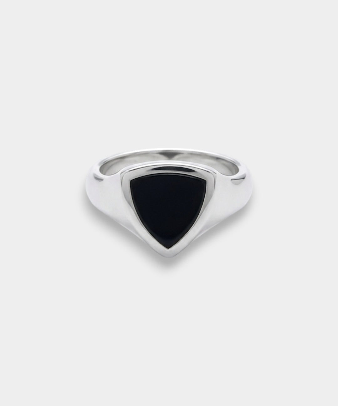 Silver ring with a black triangular stone on a white background
