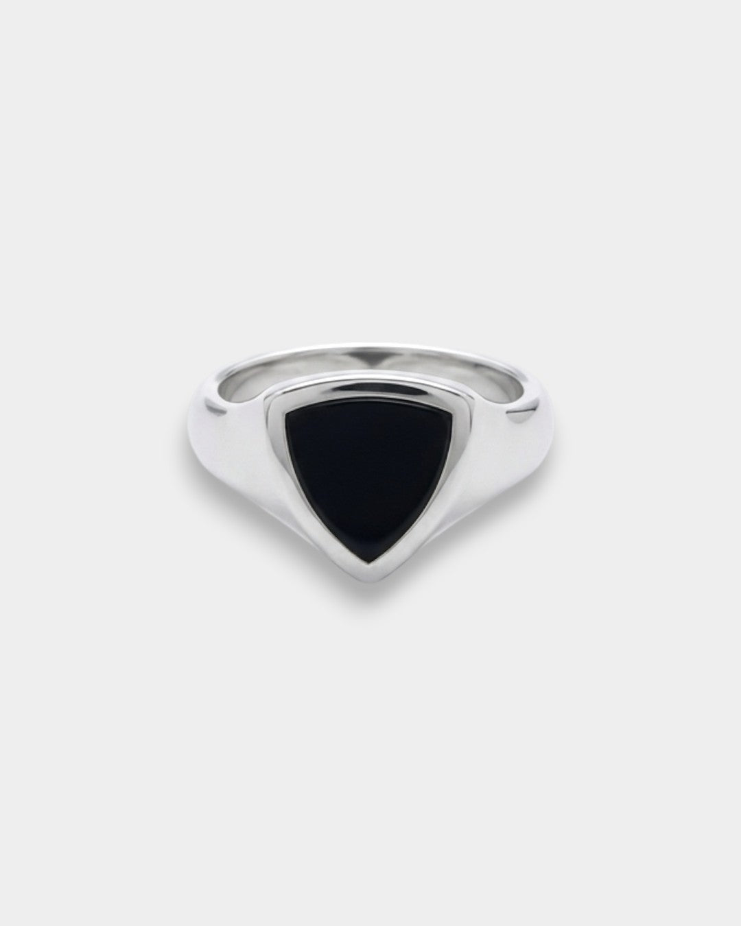 Silver ring with a black triangular stone on a white background