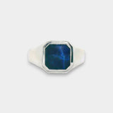 Silver ring with a blue stone on a white background