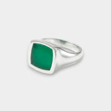 Silver ring with a green stone on a white background