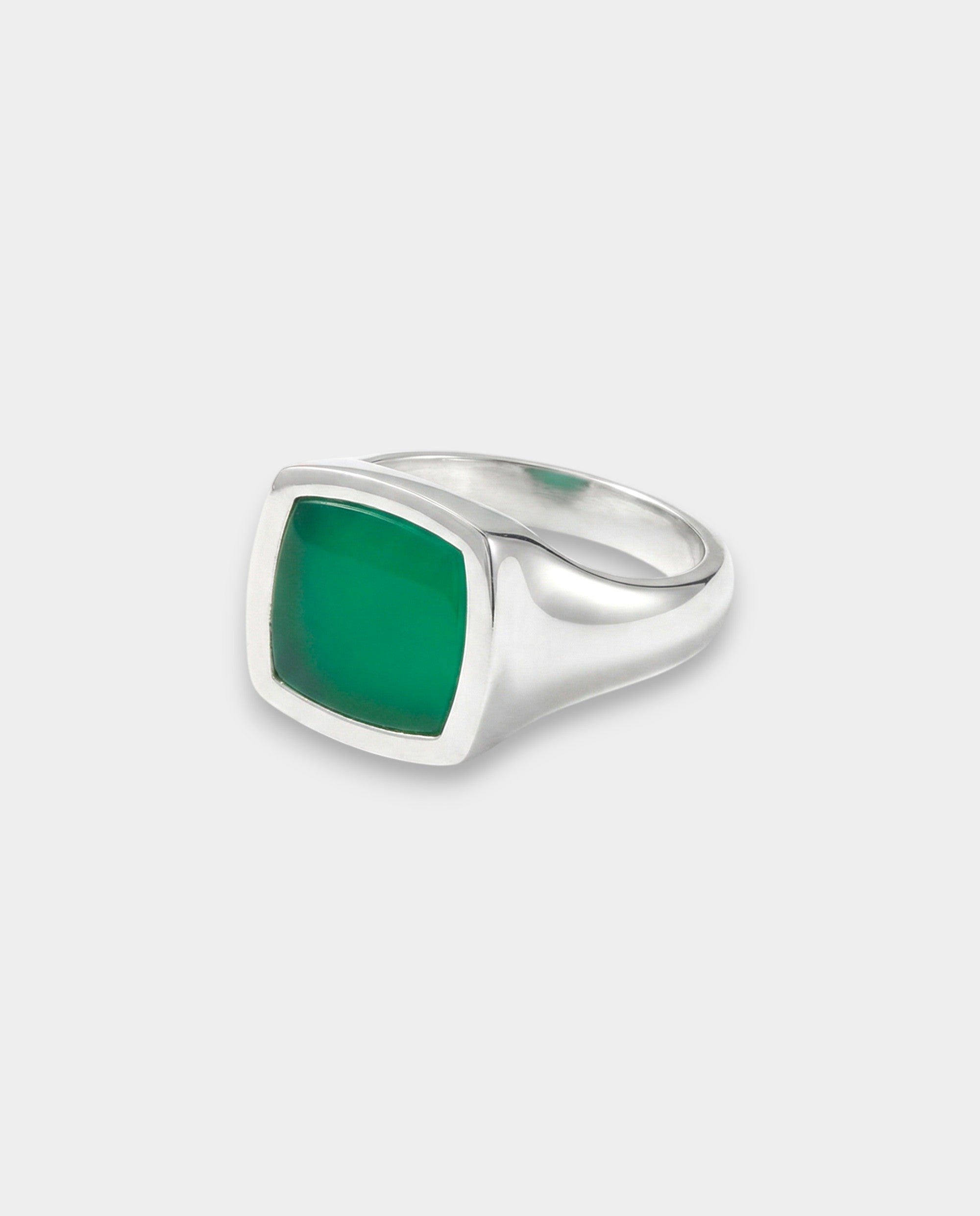 Silver ring with a green stone on a white background