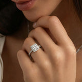 model's hand wearing a princess-cut halo engagement ring