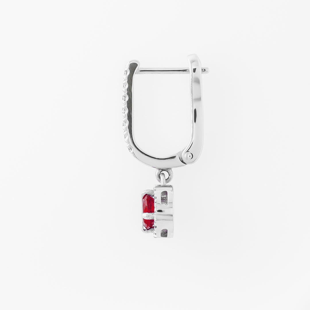 White gold hoop earring with a red ruby on a white background