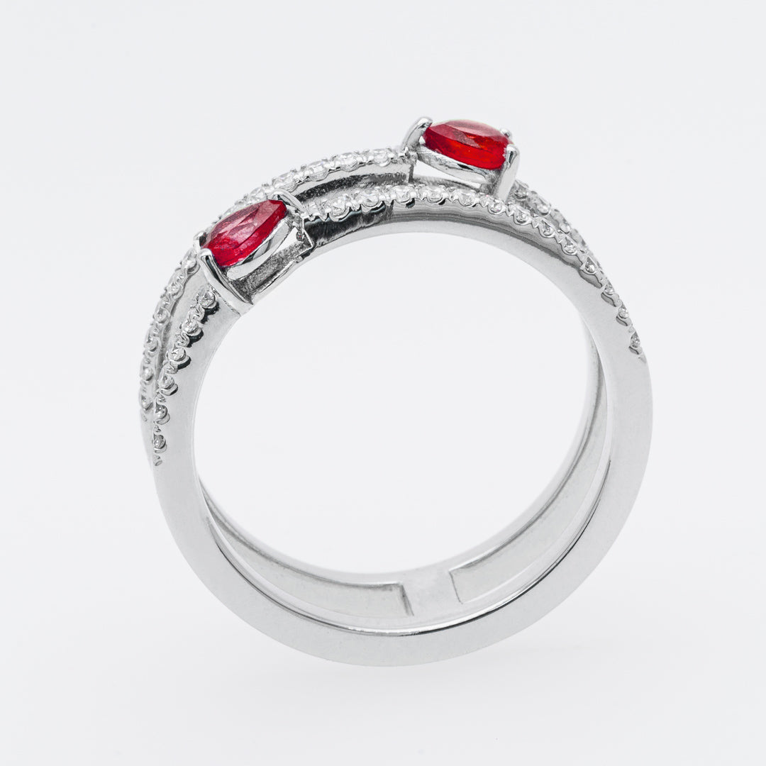 White gold ring with red rubies on a white background