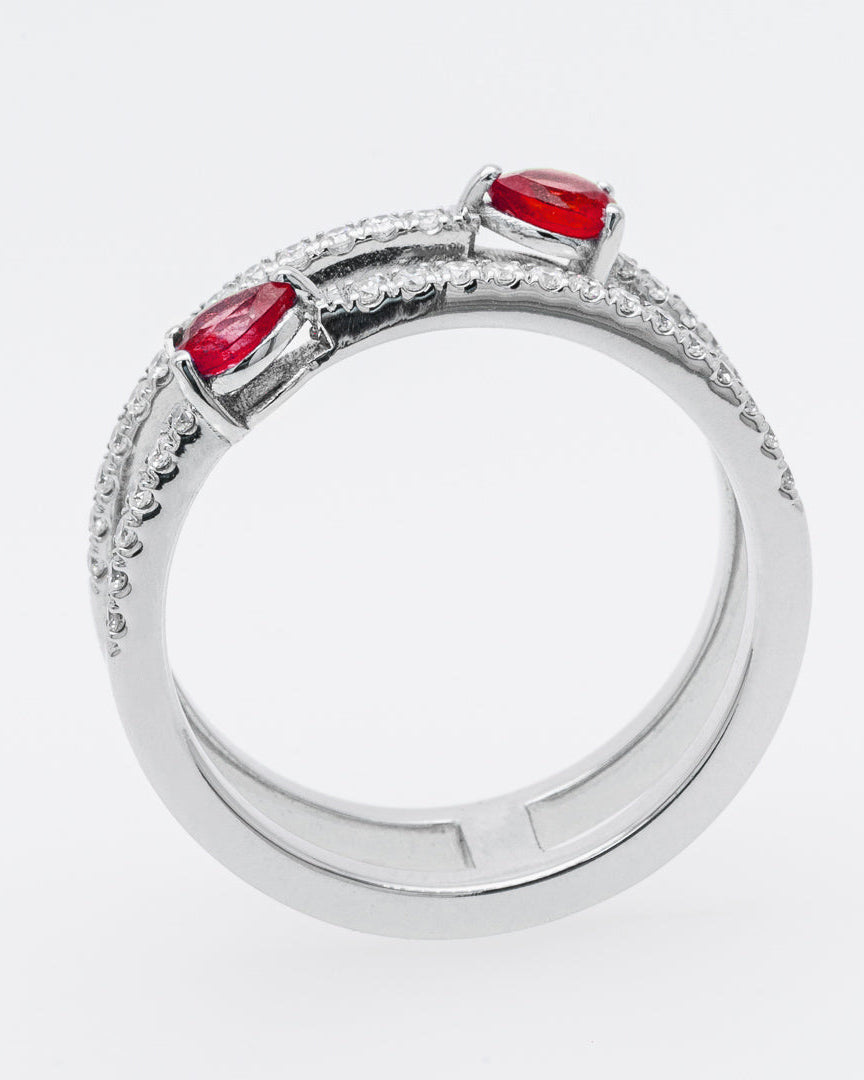 White gold ring with red rubies on a white background