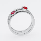 White gold ring with red rubies on a white background