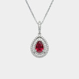Teardrop-shaped ruby pendant with diamond accents on a white background