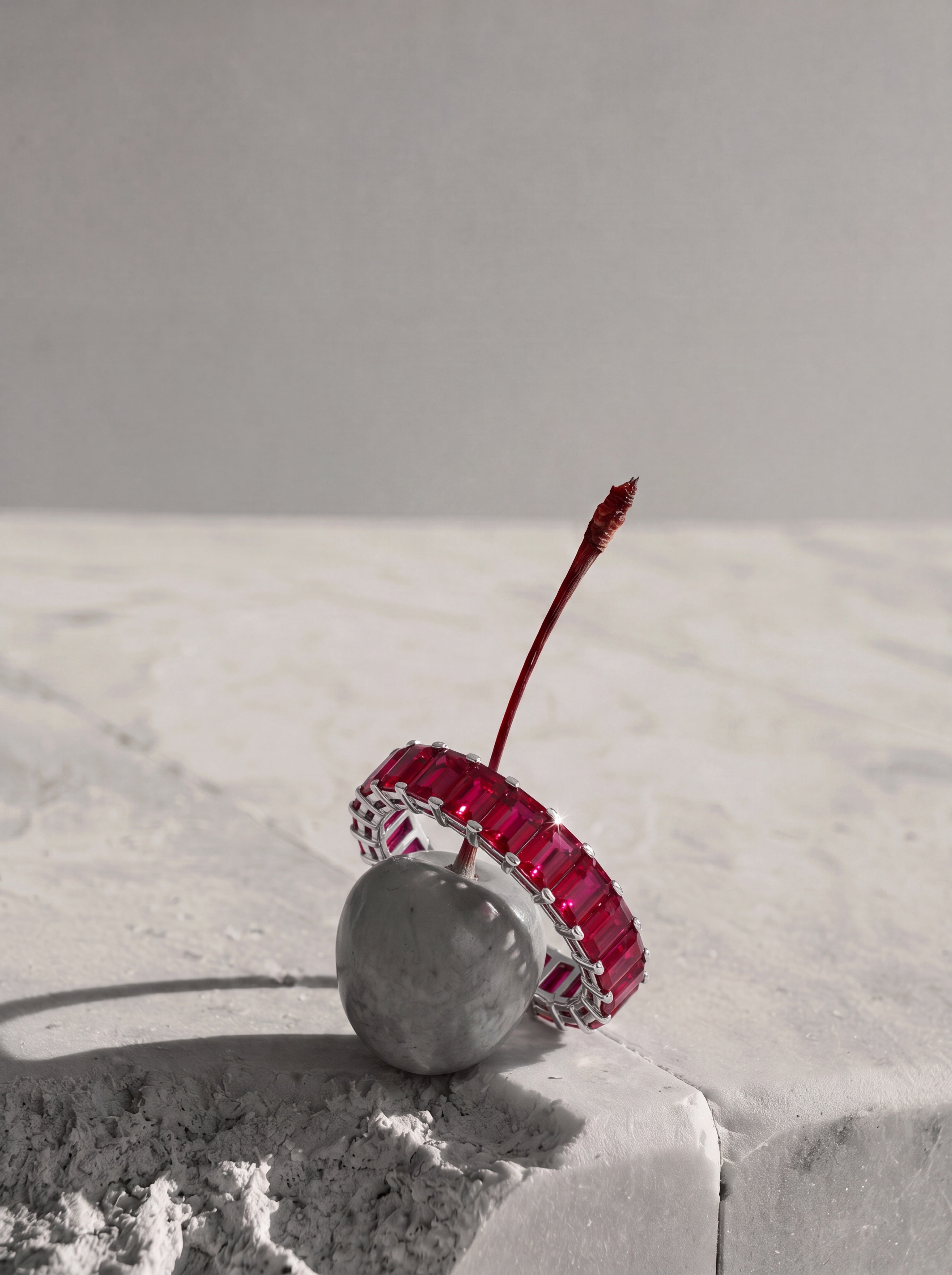 a ruby eternity ring on a cherry 