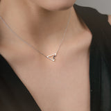 Necklace with a triangle pendant with sapphires worn by a model