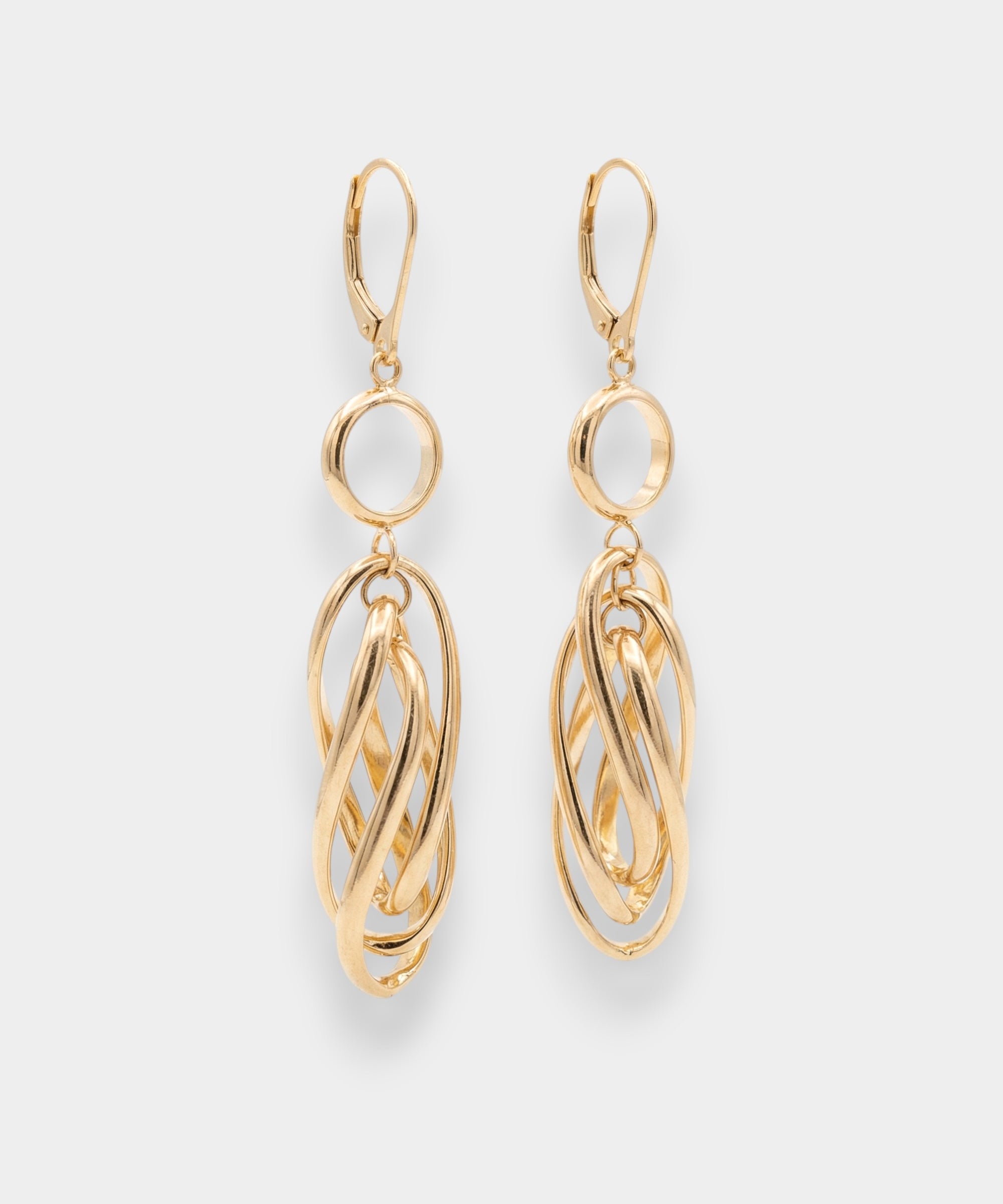 Gold hoop earrings on a light gray background
