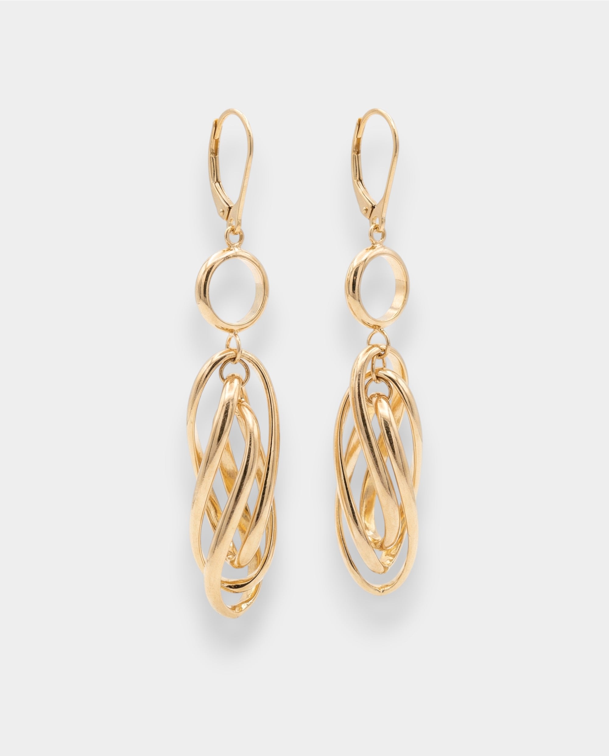 Gold hoop earrings on a light gray background