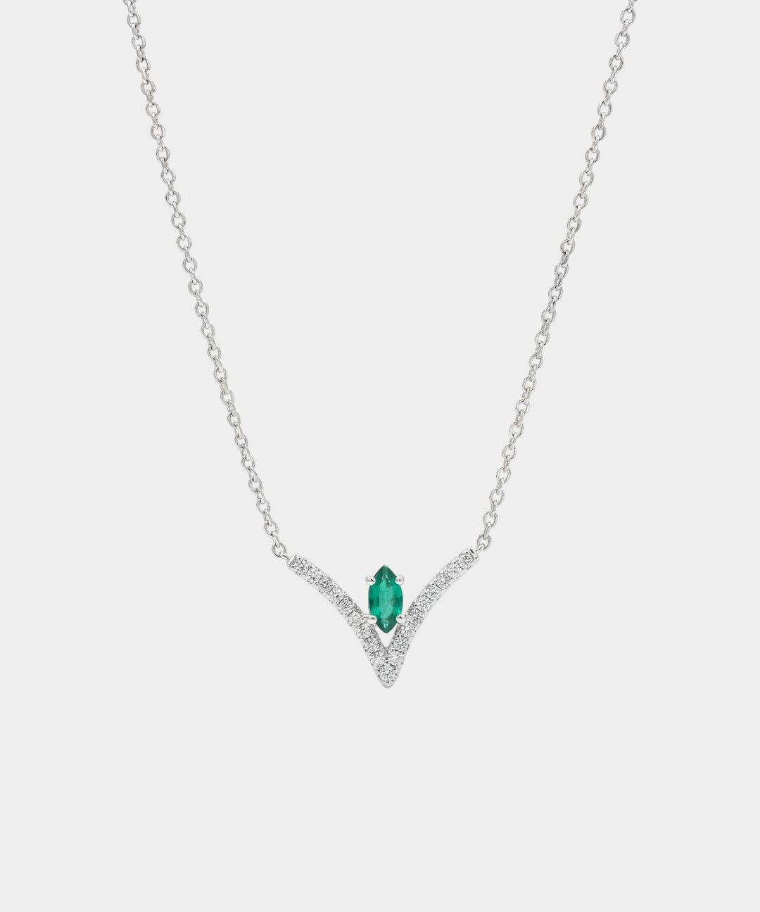 Necklace with a green gemstone pendant on a white background