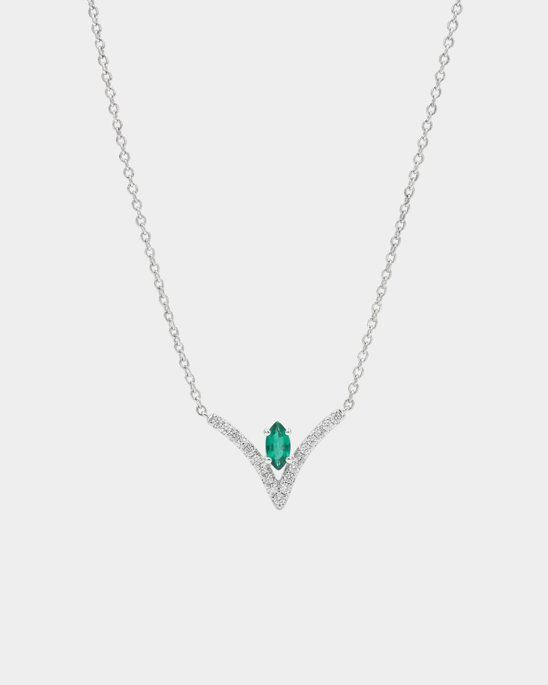 Necklace with a green gemstone pendant on a white background