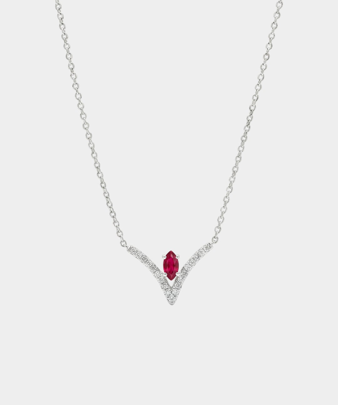 Necklace with a red gemstone and diamond accents on a white background