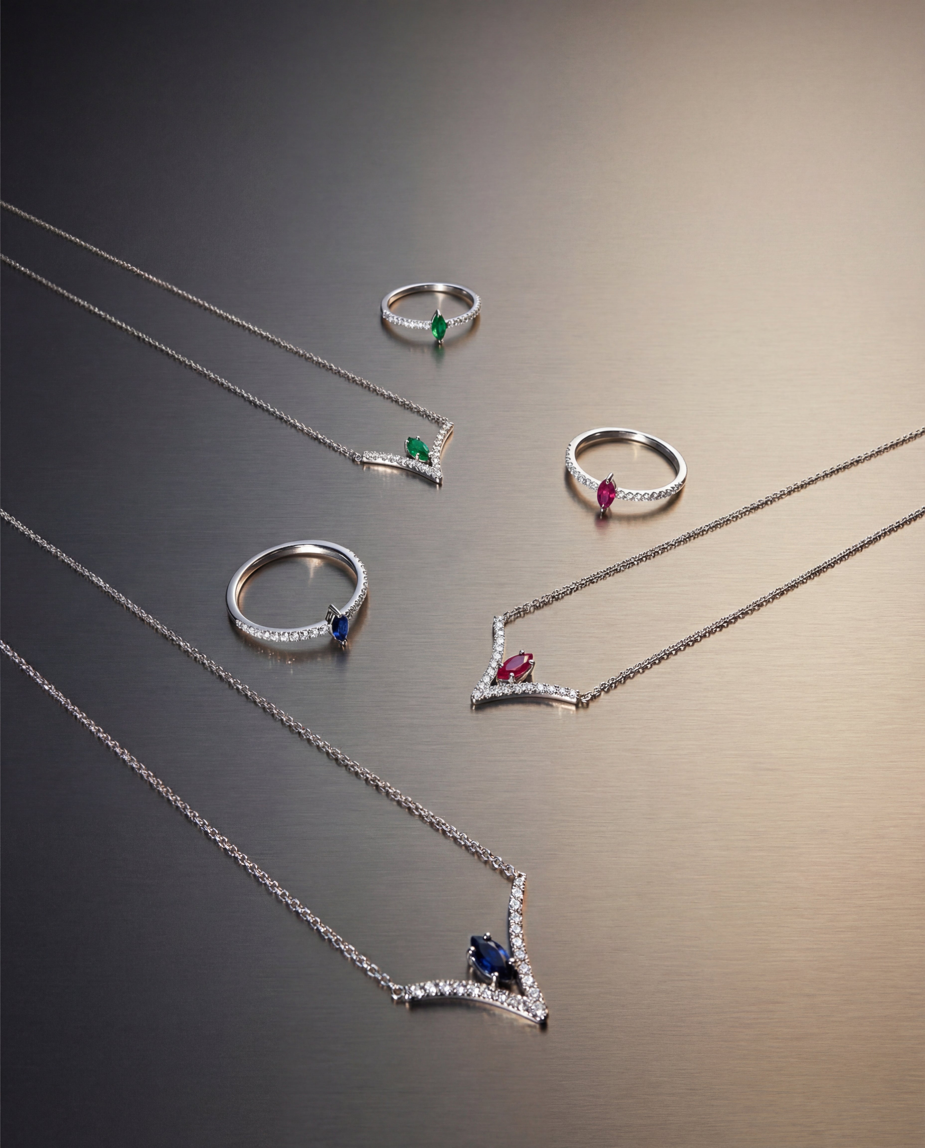 Silver jewelry set with rings and necklaces on a gradient background