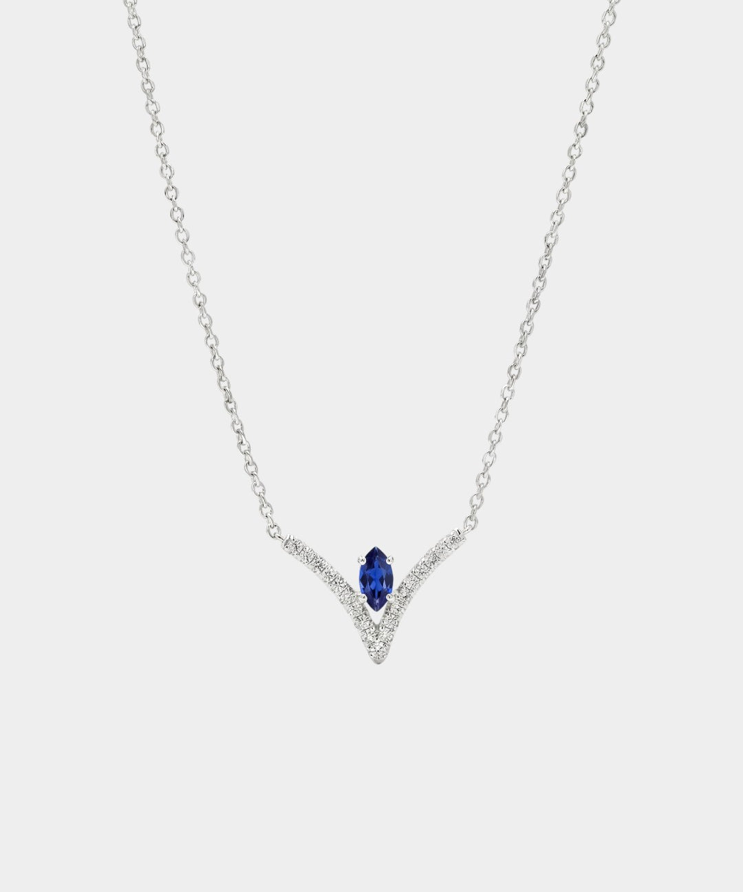 Necklace with a blue gemstone and diamond accents on a white background
