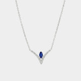 Necklace with a blue gemstone and diamond accents on a white background