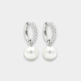 Pair of white gold hoop earrings with pearl drops on a white background